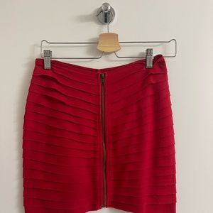 Red skirt with pleating all around and zipper down the front